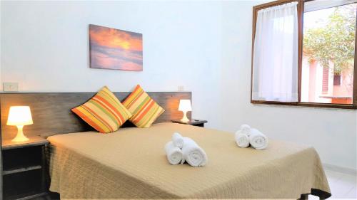 Postel nebo postele na pokoji v ubytování Ferienhaus Casa Sole - Villaggio Galanu