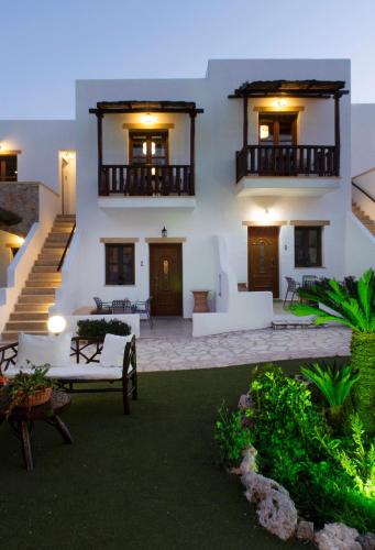a large white building with two balconies and a patio at Panteli Beach Hotel in Panteli