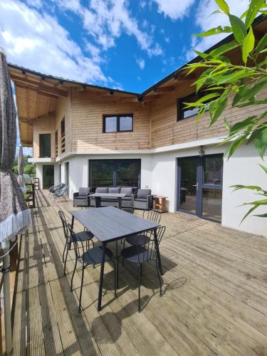 a patio with a table and chairs on a deck at Bran Mountain Living in Bran