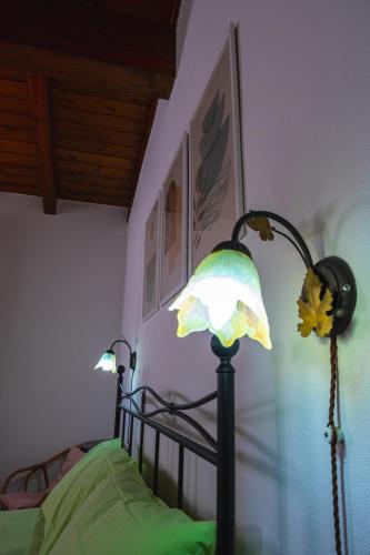 a bedroom with a bed with two lamps on it at Funtana'e Mari in Gonnesa
