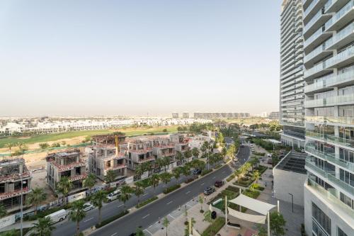 an aerial view of a city with tall buildings at Nasma Luxury Stays - Charming Studio at DAMAC Hills Artesia Tower C in Dubai