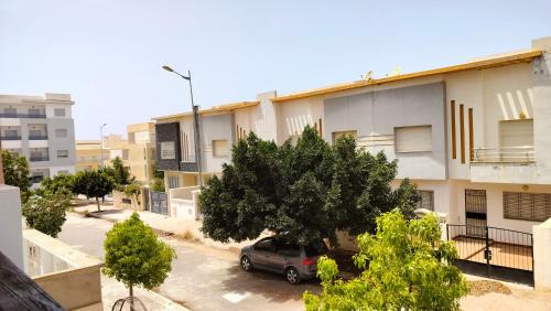 a car parked in a parking lot in front of a building at Dar Amora in Ras El Ma