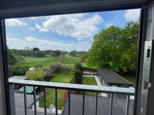 a window view of a yard from a balcony at LUXURIOUS HOLIDAY HOME Bolton in Bolton