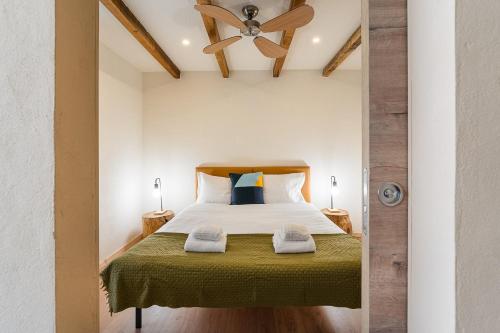 a bedroom with a bed with a ceiling fan at GuestReady - Modern Home In Gaia in Vila Nova de Gaia