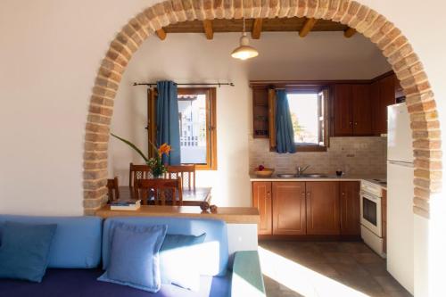 a living room with a blue couch in a kitchen at Panteli Beach Hotel in Panteli