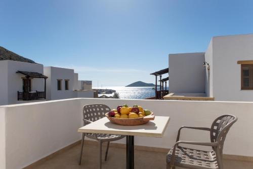 a table with a bowl of fruit on a balcony at Panteli Beach Hotel in Panteli