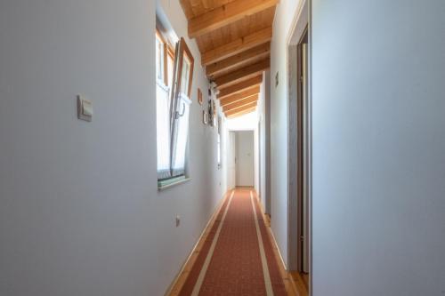 a hallway with white walls and a wooden ceiling at Villa Sandi, mediterranean Villa with pool and jacuzzi in Gračišće
