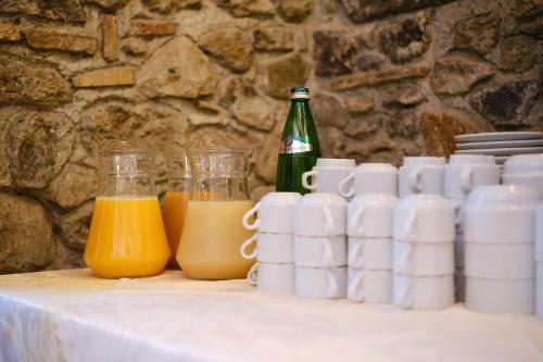 a table with cups and bottles of orange juice at Albergo Della Posta in Bracciano