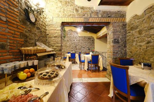 a restaurant with a table and chairs in a room at Albergo Della Posta in Bracciano