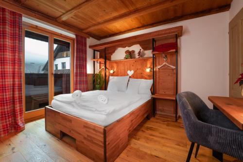 a bedroom with a bed and a large window at Gostilna Pri Martinu in Kranjska Gora