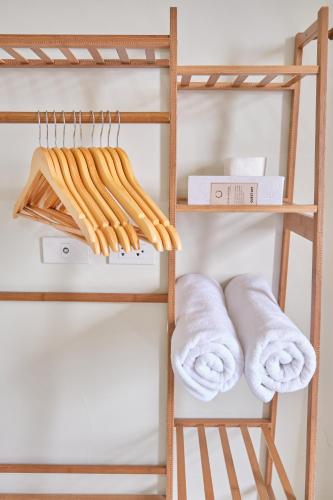 a stack of towels on a shelf in a room at QFandZ Baguio Homestay at BRENTHILL Condominium in Baguio