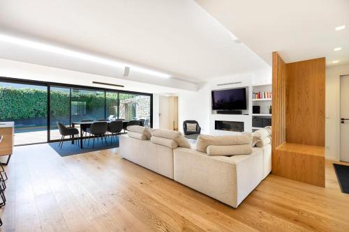 a living room with a couch and a dining room at Rosario Pool Villa in Cascais