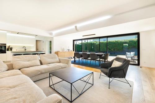 a living room with a couch and chairs and a table at Rosario Pool Villa in Cascais