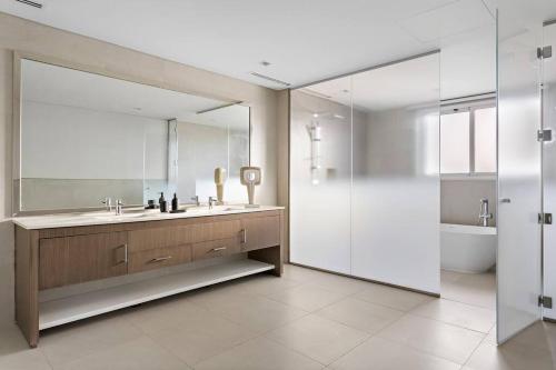 a bathroom with a sink and a mirror and a tub at World Class VILLA Exclusive & Seaside Splendor in Dubai