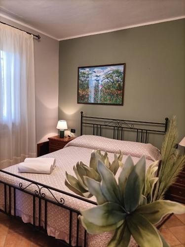 a bedroom with a bed with a plant on it at Il Melograno in Torino di Sangro