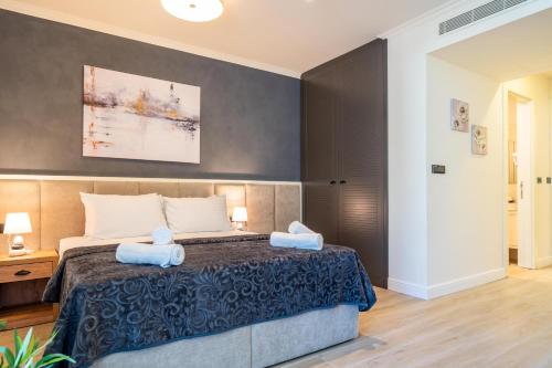 a bedroom with a bed with two towels on it at Invictus Hotel in Budva
