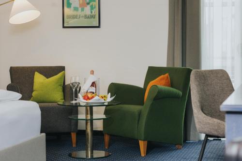 a living room with two chairs and a table at Gutshof Sagmühle in Bad Griesbach