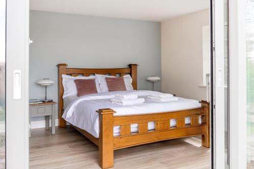 a bedroom with a bed with two towels on it at Patch House Glengarriff in Glengarriff