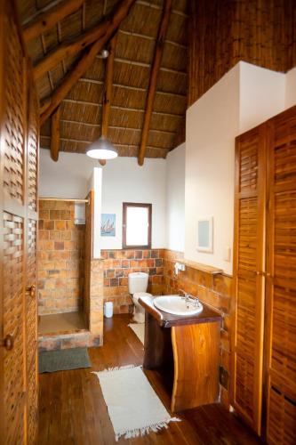 a bathroom with a sink and a toilet at Sia Sente Beach estate in Inhambane