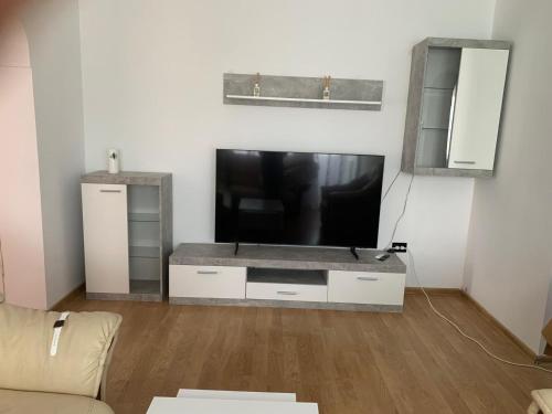 a living room with a large flat screen tv at Apartament închiriere in Târgovişte
