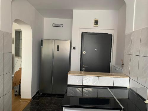 a kitchen with a refrigerator and a counter top at Apartament închiriere in Târgovişte