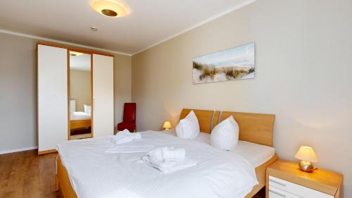 Postel nebo postele na pokoji v ubytování strandnahe FeWo mit Balkon,Residenz Bel Vital 15