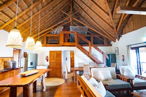 a living room with a dining table and a loft at Sia Sente Beach estate in Inhambane
