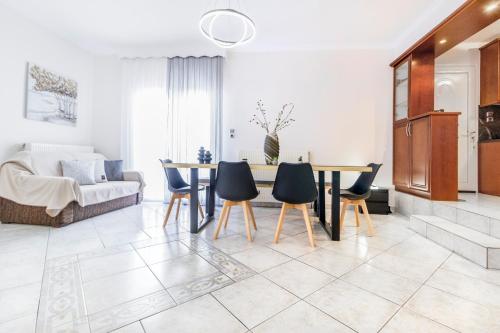 a living room with a table and chairs at Nasia House Paliouri in Paliouri