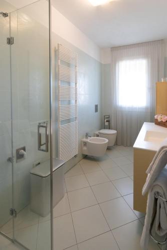 a bathroom with a shower and a sink and a toilet at Seventyfive House in Chioggia