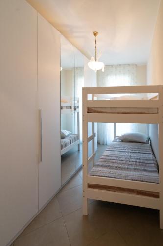 a bedroom with a bunk bed and a closet at Seventyfive House in Chioggia