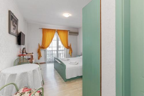a hospital room with a bed and a window at Sun Guest House in Budva