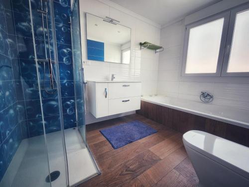 a bathroom with a shower and a toilet and a sink at Casa del Arenal - Laxe in Laxe