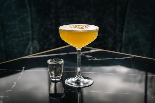 a drink in a martini glass next to a glass at Gleneagle River Apartments in Killarney
