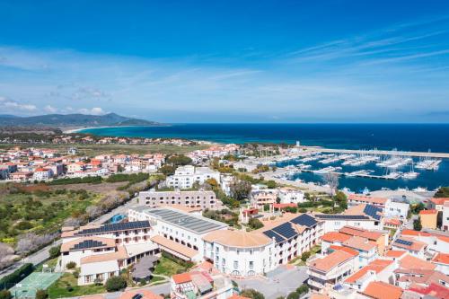 an aerial view of a city and the ocean at Cala Della Torre Resort in La Caletta