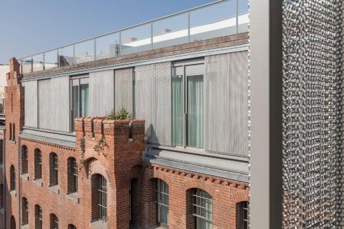 a brick building with a planter on top of it at Wilmina Hotel in Berlin