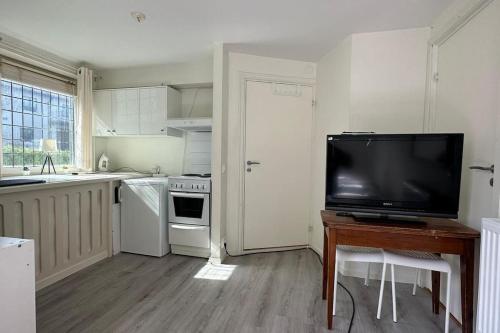 a kitchen with a flat screen tv on a table at Superhomes 1 gäst in Gothenburg