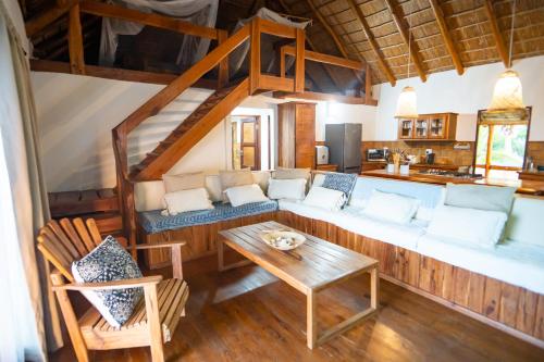 a living room with a couch and a table at Sia Sente Beach estate in Inhambane