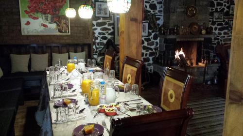 a table in a restaurant with a white table cloth at Guest House Bujtina Leon in Korçë