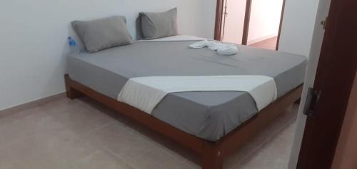 a bed in a room with a white bedspread at Villa Paradiso in Wadduwa