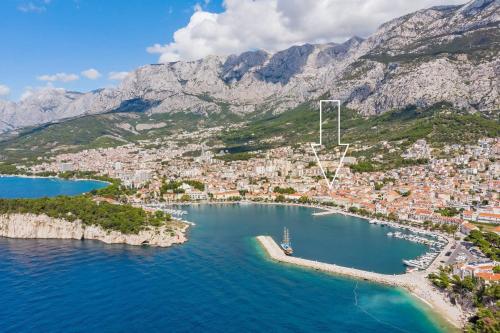 an aerial view of a city with a harbor at Villa Filipetti in Makarska center, 4 en-suite bedrooms charming stone house, heated private pool, 600m from beach in Makarska