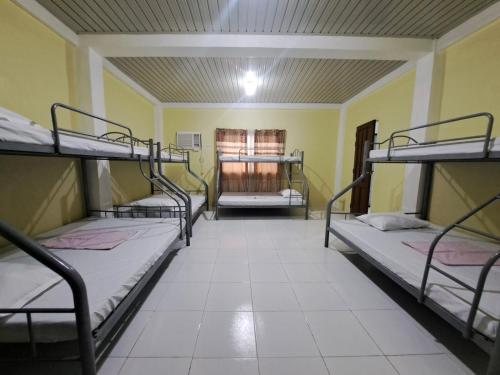 a room with four bunk beds in it at Lucky one transient 3mins walk from whart in Alaminos