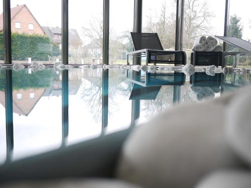 a room with a pool of water and a table at Logis Hotel Restaurant A L'Etoile in Mittelhausen