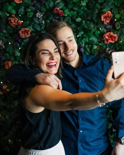a man and a woman taking a picture with a cell phone at Arctic City Hotel in Rovaniemi