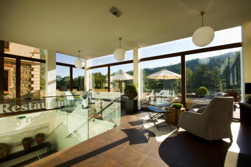 a living room with glass walls and a large window at Wellness & spa hotel Augustiniánský dům in Luhačovice