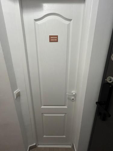 a door in a bathroom with a sign on it at Romana Boutique in Bucharest