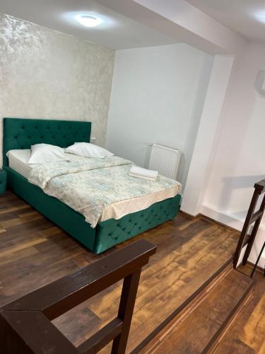 a bedroom with a green bed in a room at Romana Boutique in Bucharest