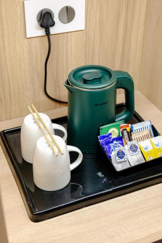 a tray with cups and chopsticks on a table at Signature Hotel in Ajmer