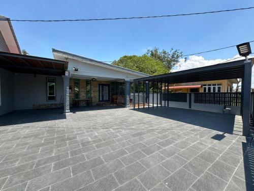 an empty parking lot in front of a building at Rayyan Ashraf homestay in Kota Bharu