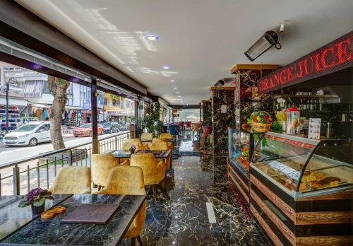 a restaurant with tables and chairs in a store at Avlion Boutique Hotel in Alanya