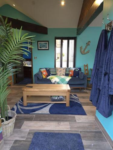 a living room with a couch and a coffee table at Farm Elegance at Lottie's Lodge in Hutton